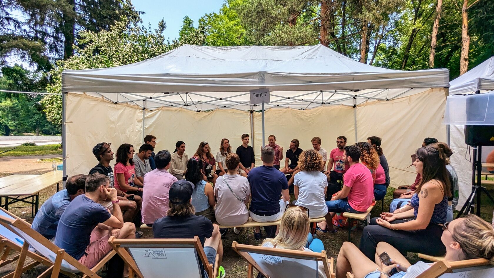 People seated in a discussion circle at Bansko Nomad Fest