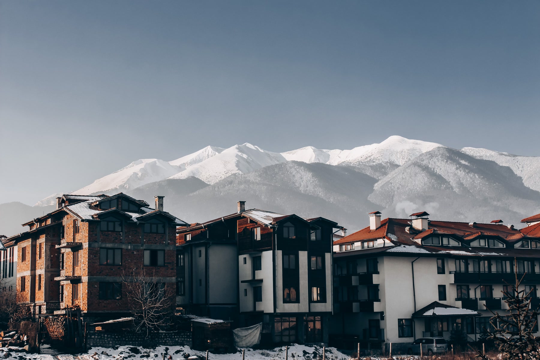 Bansko buildings below snow-covered Pirin Mountains